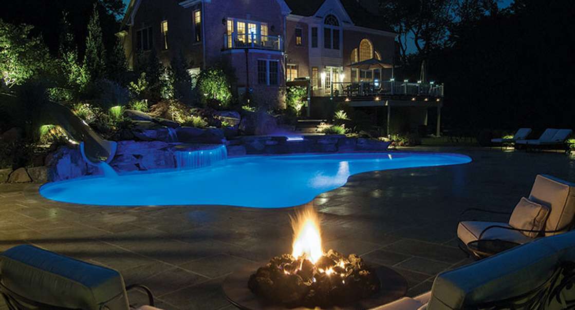 An image of a pool in a backyard late at night